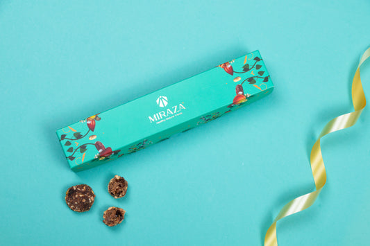 Teal gift box with floral design and 'MIRAZA' branding on a turquoise background