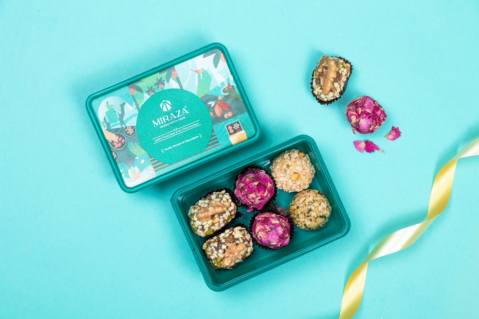 Green tin with colorful treats on a blue background